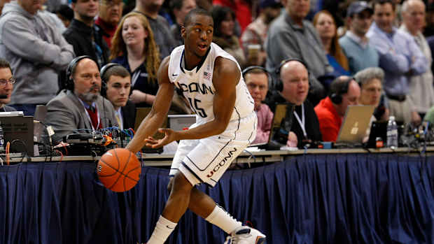 Connecticut Huskies guard Kemba Walker grabs the ball.